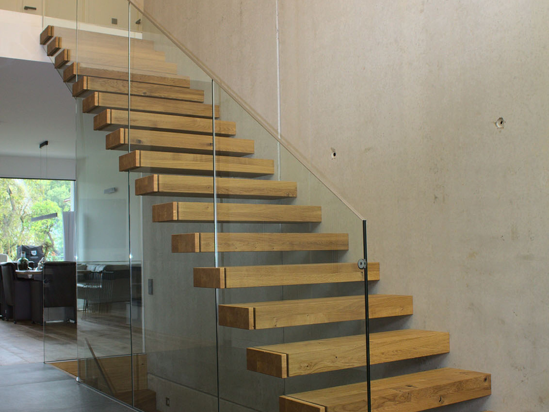 Kragstufentreppe mit durchgehendem Glasgeländer